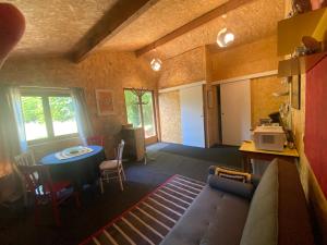 a living room with a couch and a table at La Cabane des Bains in Marciac +5 photos
