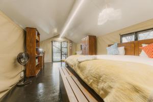 a bedroom with a large bed and a fan at The Explorers Camp in Renos