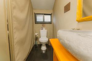 a small bathroom with a toilet and a sink at The Explorers Camp in Renos +43 photos