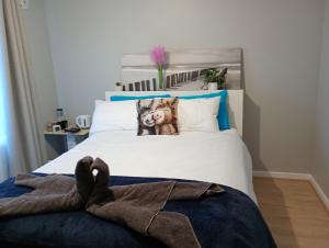 a bedroom with a bed with a stuffed animal on it at Budget Friendly Accommodation in Mandurah