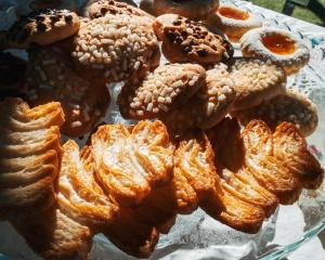 a bunch of pastries sitting on a glass plate at B&B LE GRETTE in Gioia dei Marsi +34 photos