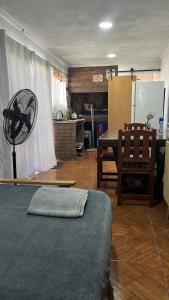 a living room with a table and a dining room at El quincho in San Pedro