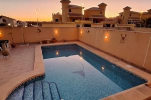 a swimming pool on the roof of a house at Salona Geus in Algorfa