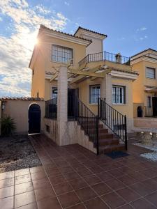 a large house with a staircase in front of it at Salona Geus in Algorfa