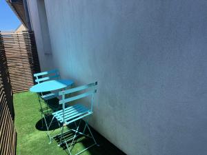 a blue table and a chair on a balcony at Les Nuits Douces in Bitche