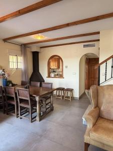 a dining room with a wooden table and chairs at Salona Geus in Algorfa