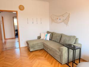 a living room with a couch and a wooden floor at TIMO Apartment Split Croatia in Kaštela