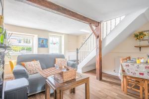 a living room with a couch and a table at Charming Cottage, Lake District in Little Broughton