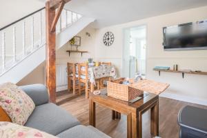 a living room with a couch and a table at Charming Cottage, Lake District in Little Broughton