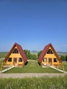 a group of three houses in a field at Domaćinstvo Krstajić - Rural holiday in Žabljak