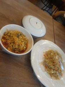 a table with two bowls of soup and plates of food at Valley in Kado