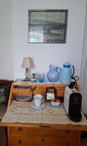 a wooden table with a toaster and a microwave at Haus Rieder in Wörgl +4 photos