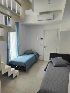a bedroom with a bed and a large window at AnnAmuri appartamento 23 in Belpasso