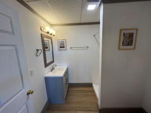 a white bathroom with a sink and a mirror at Athens House number 7A in Las Vegas