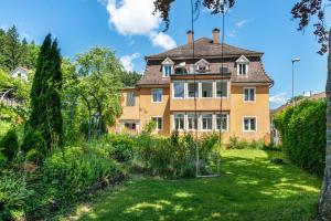 an old house with a garden in front of it at Apartment In A Historic Villa in Stockach