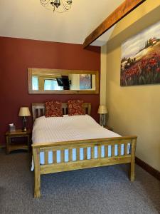 a bedroom with a bed and a painting on the wall at Old Field Barn Luxury B&B in Attleborough