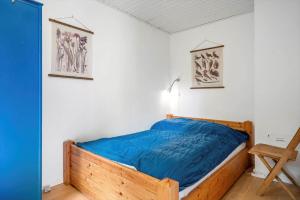 a bedroom with a bed with a blue comforter at 4044-Borre-Klintholm-Havnevej-40 in Borre