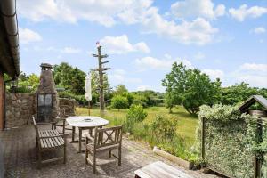 a patio with a table and chairs and a garden at 4044-Borre-Klintholm-Havnevej-40 in Borre +12 photos
