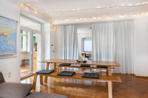 a living room with a table and a couch at Apartment In A Historic Villa in Stockach