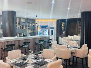 a restaurant with tables and chairs and a bar at Atlantis Hotel Lagos in Lagos