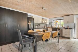 a kitchen with a dining room table and chairs at 6010-Askeby-Fanefjordgade-71 in Askeby +14 photos