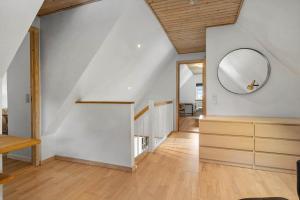 a room with a staircase and a mirror on the wall at 6010-Askeby-Fanefjordgade-71 in Askeby