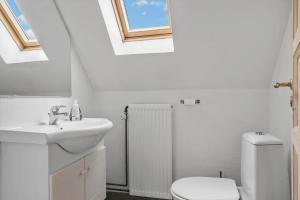 a bathroom with a sink and a toilet with skylights at 6010-Askeby-Fanefjordgade-71 in Askeby