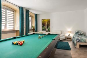 a living room with a pool table with balls on it at Apartment In A Historic Villa in Stockach