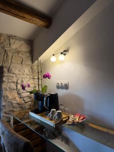 a kitchen with a counter with a coffee maker on it at Tea Rooms III in Bale +8 photos