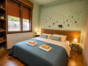 a bedroom with a bed with two towels on it at Sefira Homes Y in Keszthely