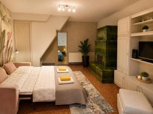 a living room with a large bed and a couch at Sefira Homes Y in Keszthely