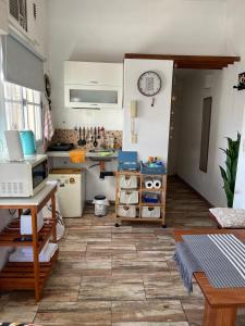 a room with a kitchen with a counter and a table at Arenales 2111 Recoleta in Buenos Aires