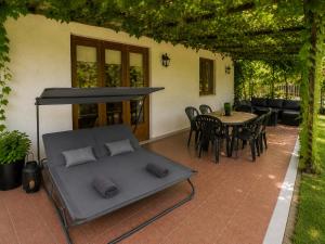 a patio with a bed and a table and chairs at Sefira Homes Y in Keszthely +9 photos