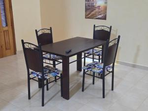 a dining room table and four chairs with a table and chairsuggest at la Citronnelle in Oualidia
