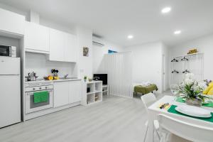 a kitchen with white appliances and a dining room at Studio New Complete 4 pax in Madrid