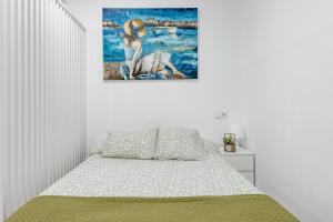 a bedroom with a bed with a painting on the wall at Studio New Complete 4 pax in Madrid +10 photos
