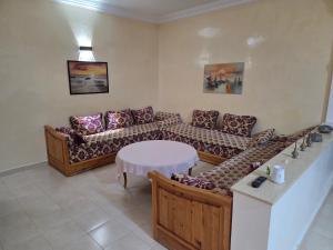 a living room with a couch and a table at la Citronnelle in Oualidia