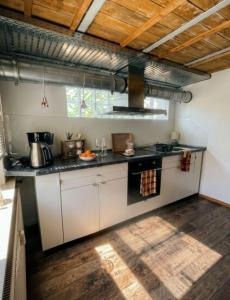 a kitchen with white cabinets and a stove top oven at die perfekte Auszeit in Illingen