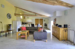 a living room with a couch and a table at La Bégude D'Amalthée in Vernay