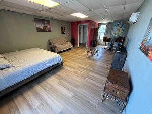 a bedroom with a bed and a chair and a couch at Athens House number 7B in Las Vegas