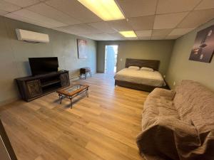 a room with a bed and a couch and a television at Athens House number 7B in Las Vegas