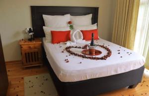 a bed with a heart made out of flowers on it at Boikhutsong Guest House in Maseru