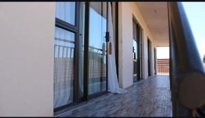 an empty hallway of a building with glass windows at Boikhutsong Guest House in Maseru