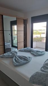 a bedroom with two beds with blankets on them at Casa Lavinia in Bregvija