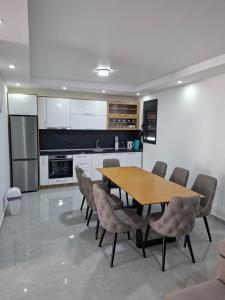 a kitchen with a wooden table and chairs at Casa Lavinia in Bregvija