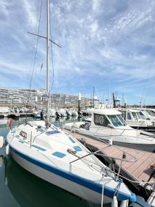 a boat docked in a marina with other boats at Nuit insolite voilier in Le Havre
