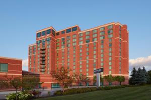 a large red building with a sign in front of it at Courtyard by Marriott Ottawa East in Ottawa