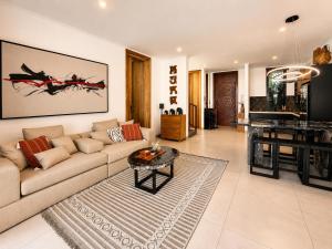 a living room with a couch and a table at Village Berawa in Badung