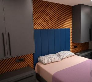 a bedroom with a bed and a blue wall at Kay-Stay in Larnaca