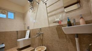 a bathroom with a sink and a toilet and a sink at Kanchi Crown Residency in Kanchipuram